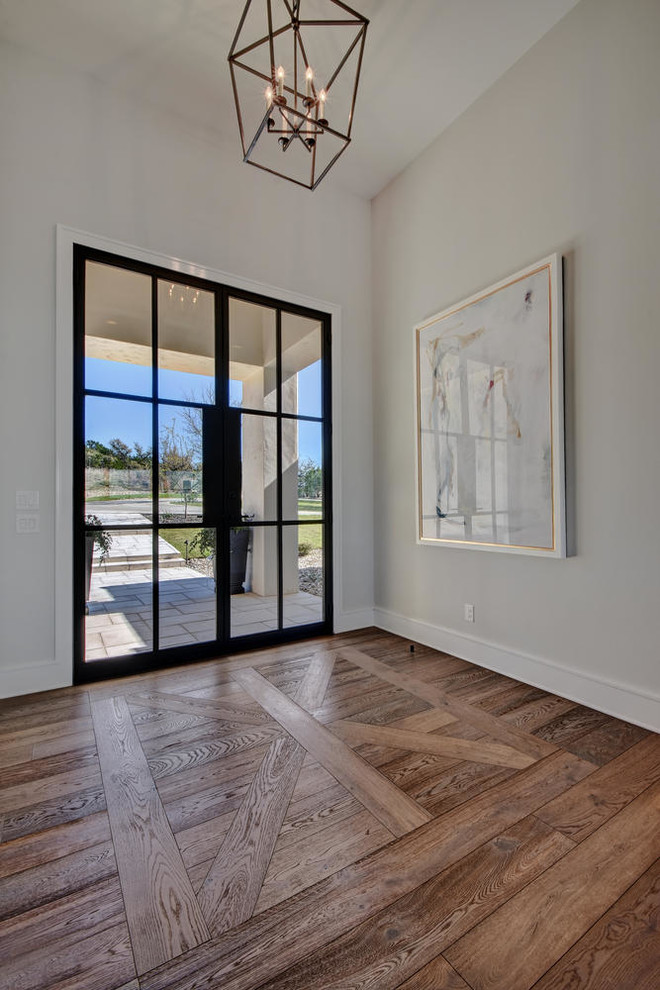 Esempio di un grande ingresso chic con pareti bianche, parquet scuro, una porta a due ante, una porta in vetro e pavimento marrone