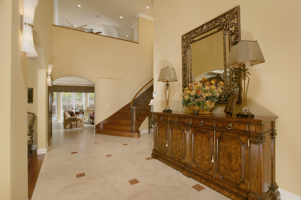 Inspiration for a timeless travertine floor entryway remodel in San Diego with yellow walls