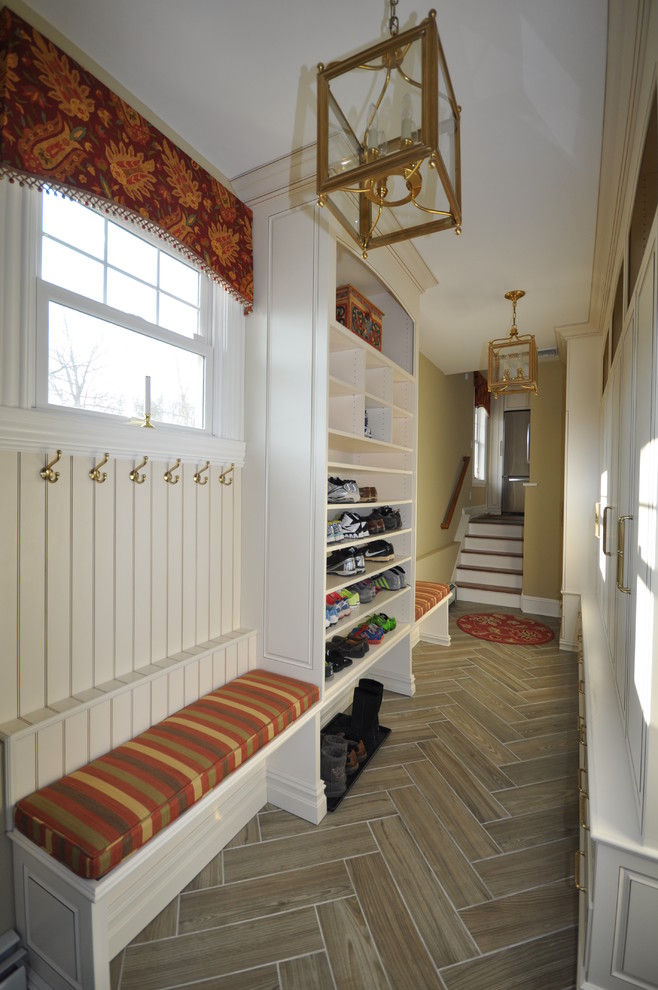 This is an example of a medium sized classic boot room in Newark with beige walls and ceramic flooring.