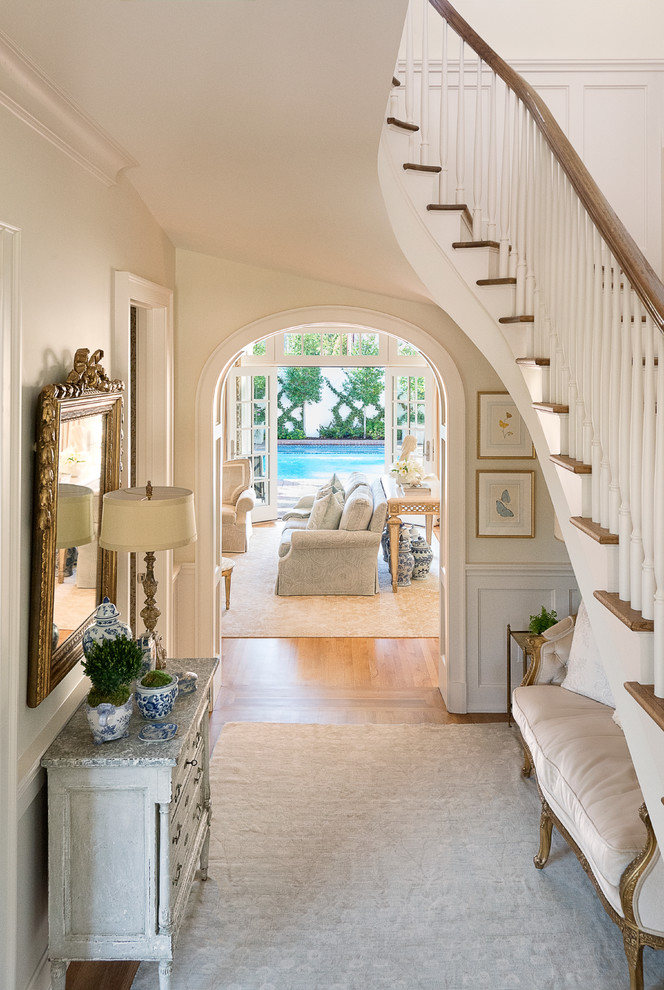 Inspiration for a medium sized eclectic foyer in Dallas with a single front door, a white front door, white walls, medium hardwood flooring, brown floors and feature lighting.