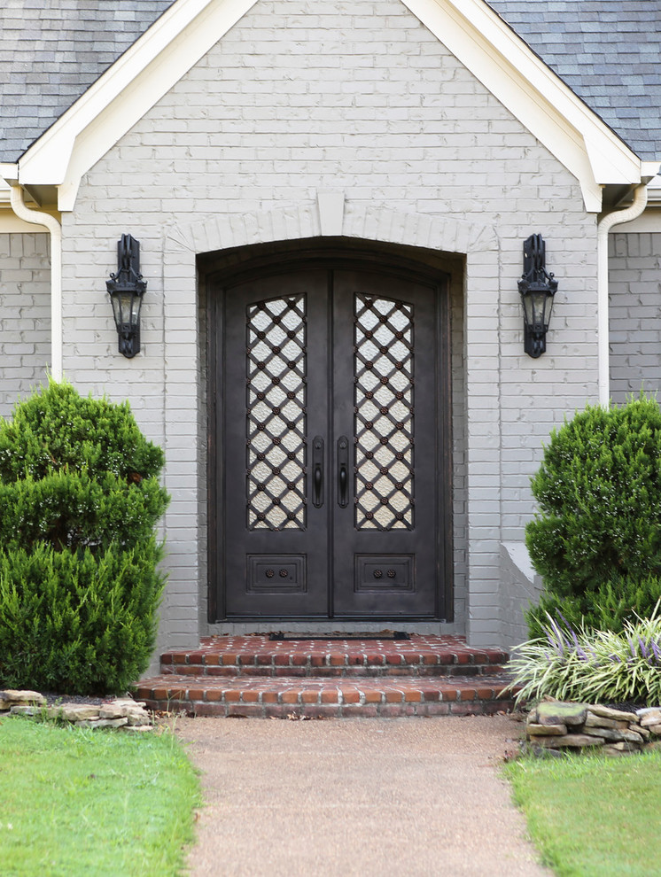 Example of a classic entryway design in Houston with a black front door