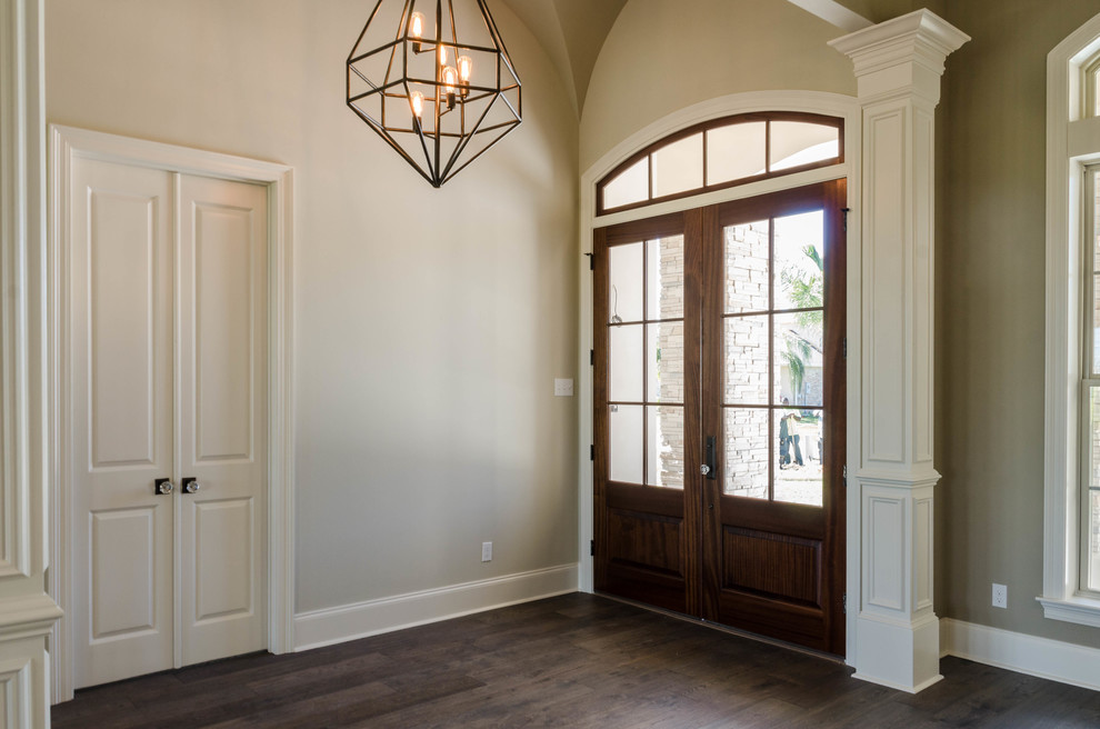 Medium sized traditional foyer in New Orleans with beige walls, medium hardwood flooring, a double front door and a dark wood front door.