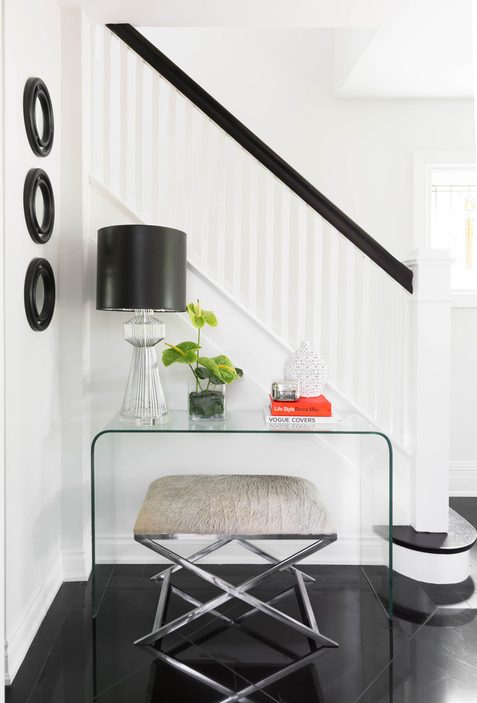 Design ideas for a medium sized classic foyer in Toronto with white walls, porcelain flooring, black floors and feature lighting.