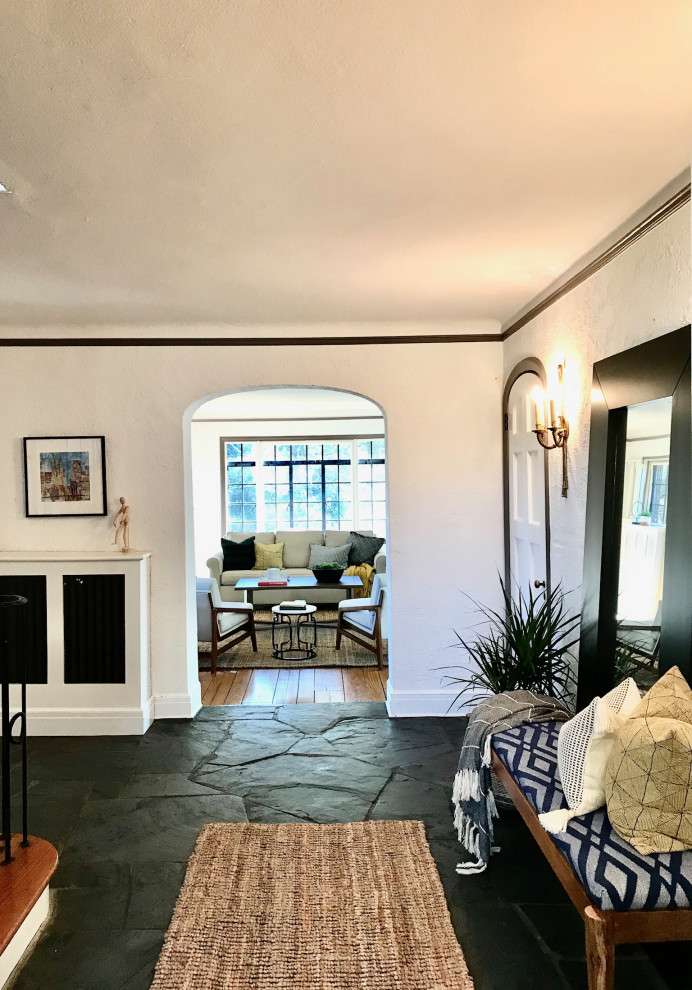 This is an example of a medium sized retro foyer in New York with white walls, slate flooring and grey floors.
