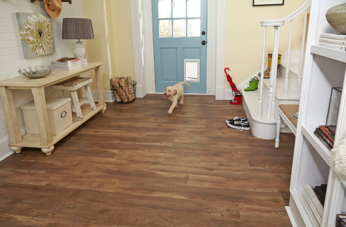 Dog-friendly luxury vinyl plank flooring adds warmth and durability to this entryway—perfect for muddy paws and high-traffic moments.