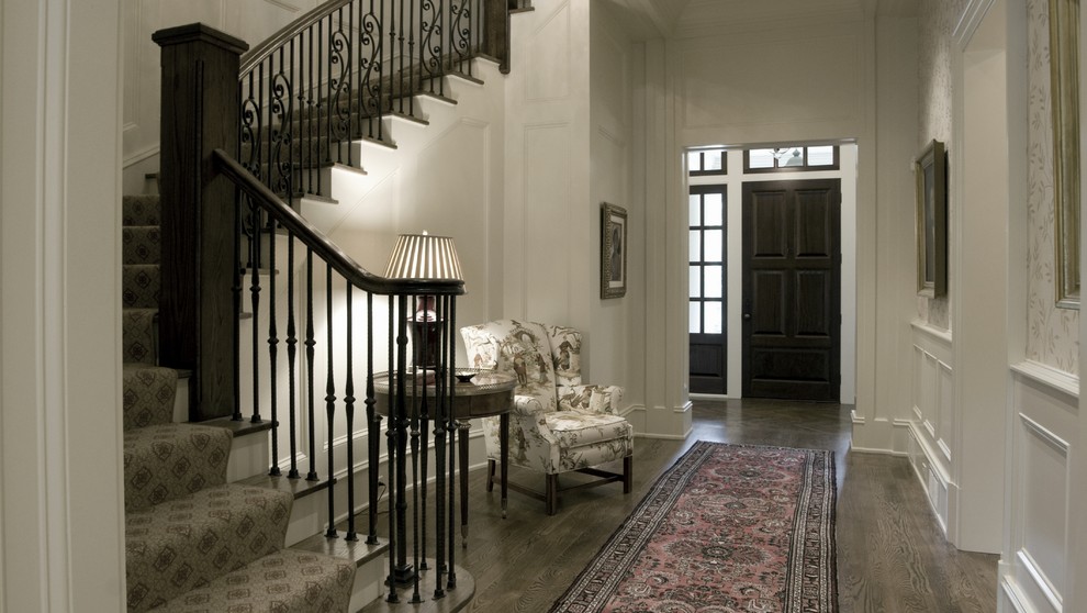 Entryway - mid-sized traditional dark wood floor and brown floor entryway idea in Atlanta with white walls and a dark wood front door