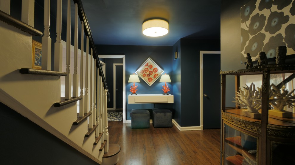 Photo of a medium sized classic entrance in New York with blue walls and dark hardwood flooring.