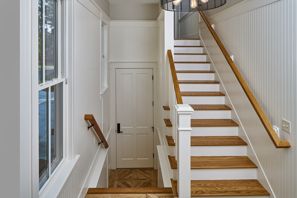 Example of a small transitional medium tone wood floor entryway design in Charleston with beige walls and a white front door