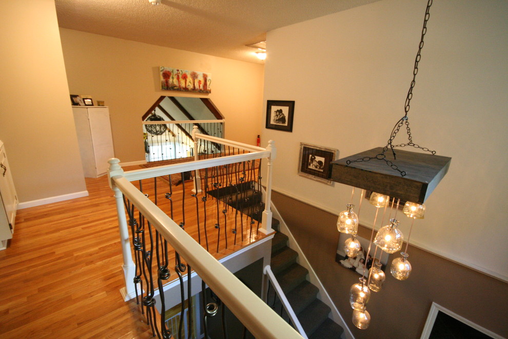 Design ideas for a medium sized eclectic foyer in Kansas City with brown walls, carpet, a single front door and a white front door.