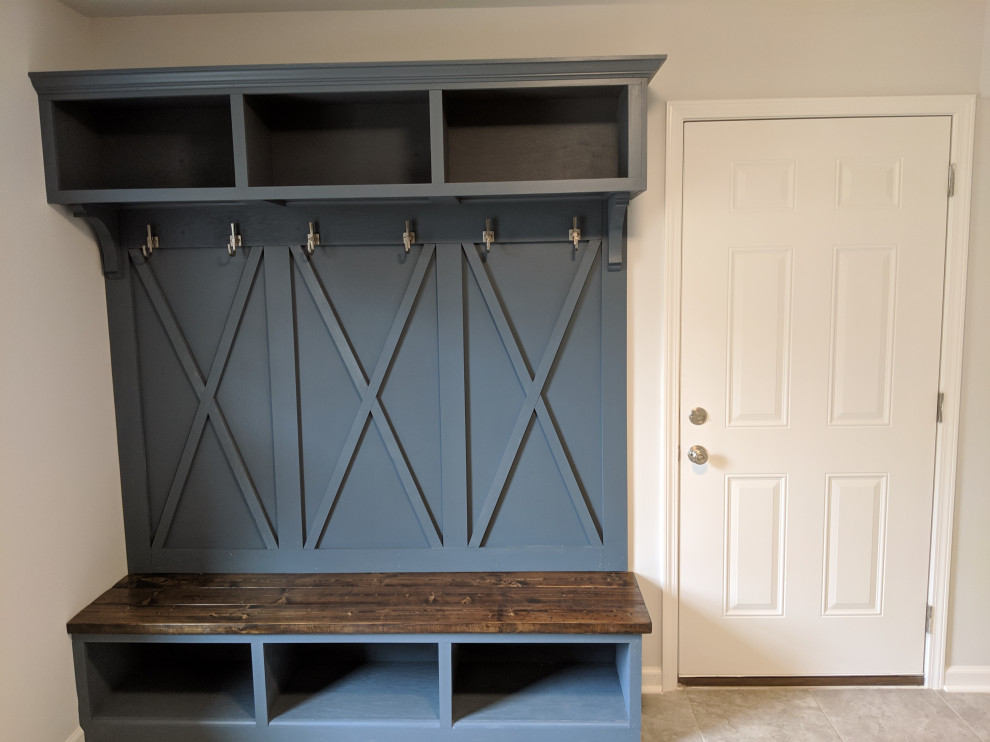 Mudroom - large country porcelain tile and gray floor mudroom idea in Raleigh
