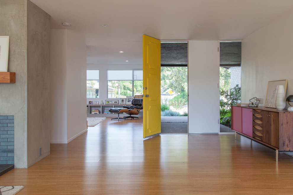 Example of a 1950s light wood floor double front door design in Los Angeles with white walls and a yellow front door