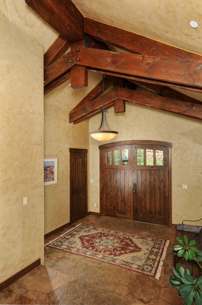 Traditional entrance in Denver with beige walls, a double front door and a dark wood front door.