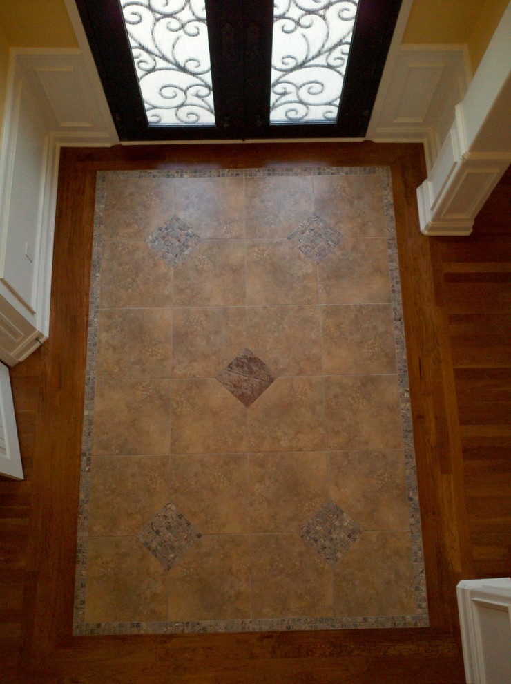 Entryway - mid-sized traditional porcelain tile entryway idea in Atlanta with yellow walls and a black front door