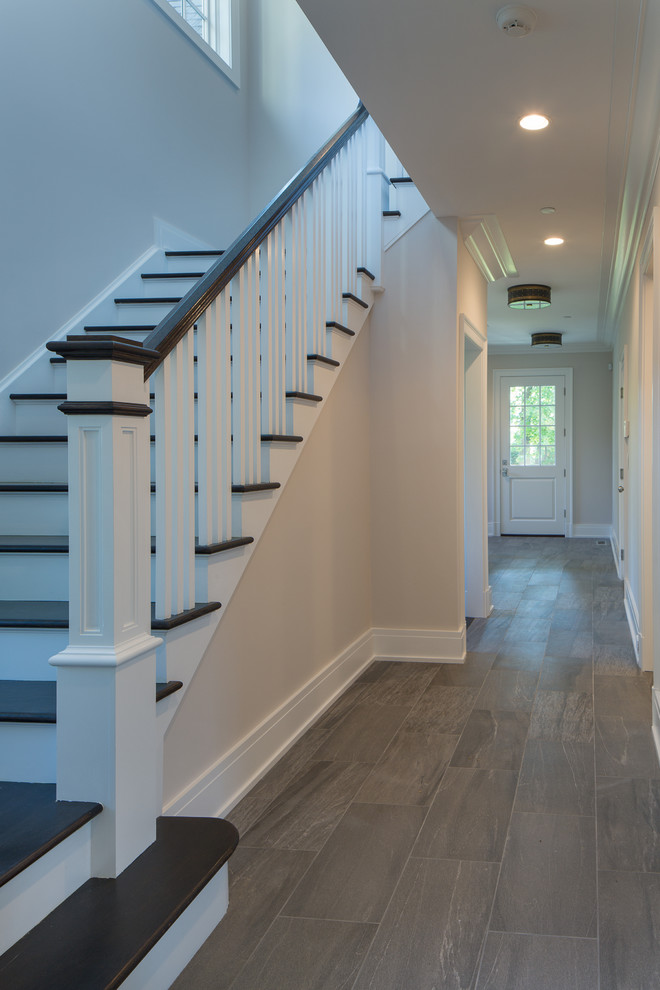 Design ideas for a medium sized classic foyer in New York with grey walls, dark hardwood flooring, a single front door and a dark wood front door.