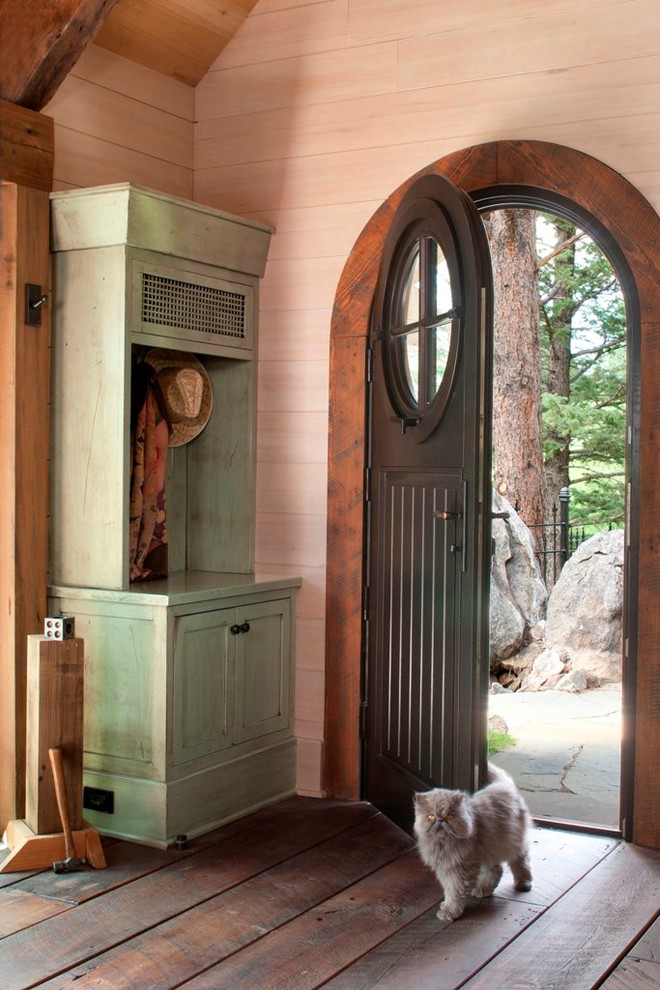 Inspiration for a small rustic entryway remodel in Denver with a black front door