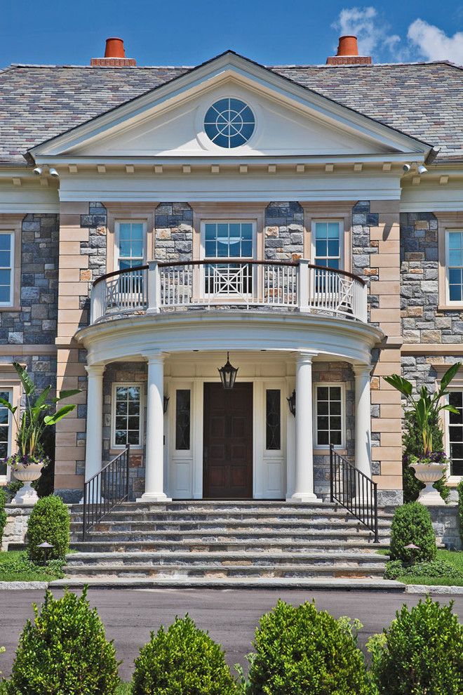 This is an example of an expansive traditional front door in New York with a single front door and a dark wood front door.