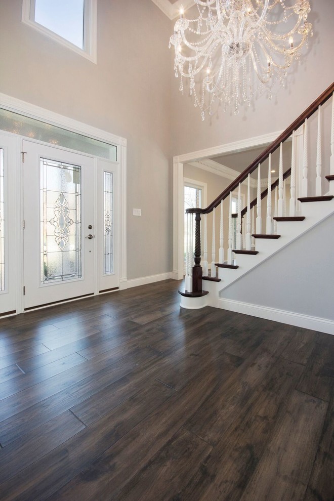 Design ideas for a medium sized traditional entrance in St Louis with grey walls, medium hardwood flooring, a single front door, a white front door and brown floors.