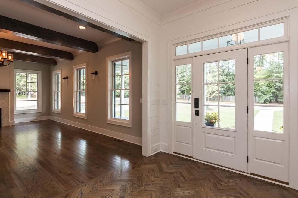 Inspiration for a large rural foyer in Raleigh with white walls, medium hardwood flooring and a single front door.
