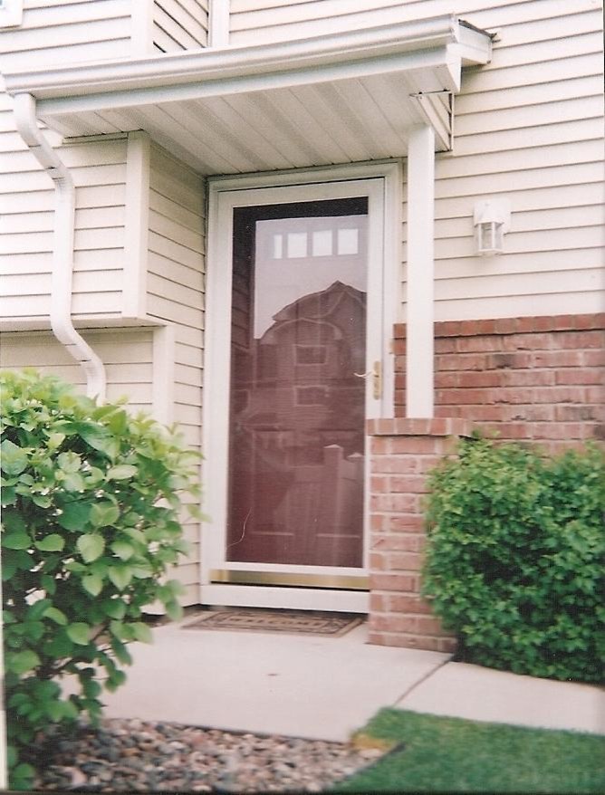 Exemple d'une porte d'entrée de taille moyenne avec un mur marron, sol en béton ciré et une porte simple.