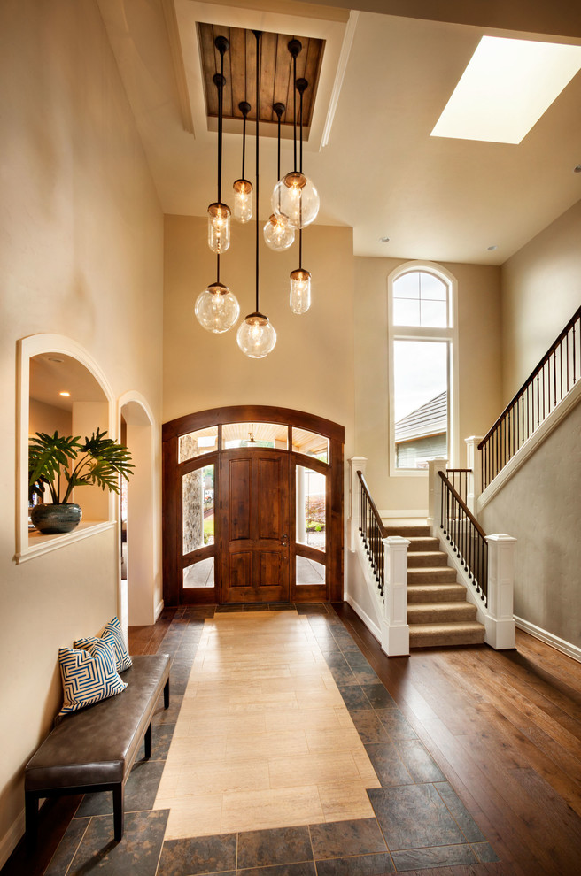 Inspiration for a large transitional dark wood floor entryway remodel in Portland with beige walls and a medium wood front door