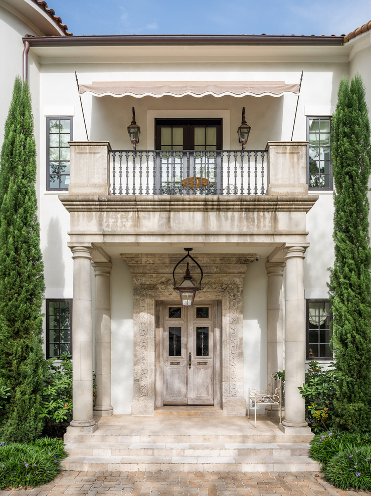 Inspiration for an expansive mediterranean front door in Houston with a double front door and a light wood front door.