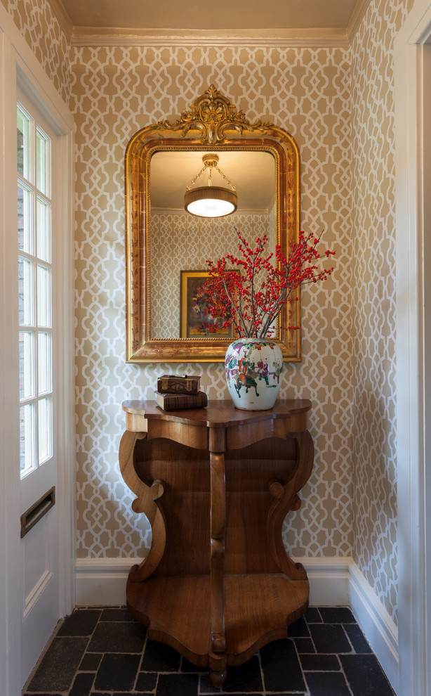 Example of a large ceramic tile vestibule design in New York with beige walls and a white front door