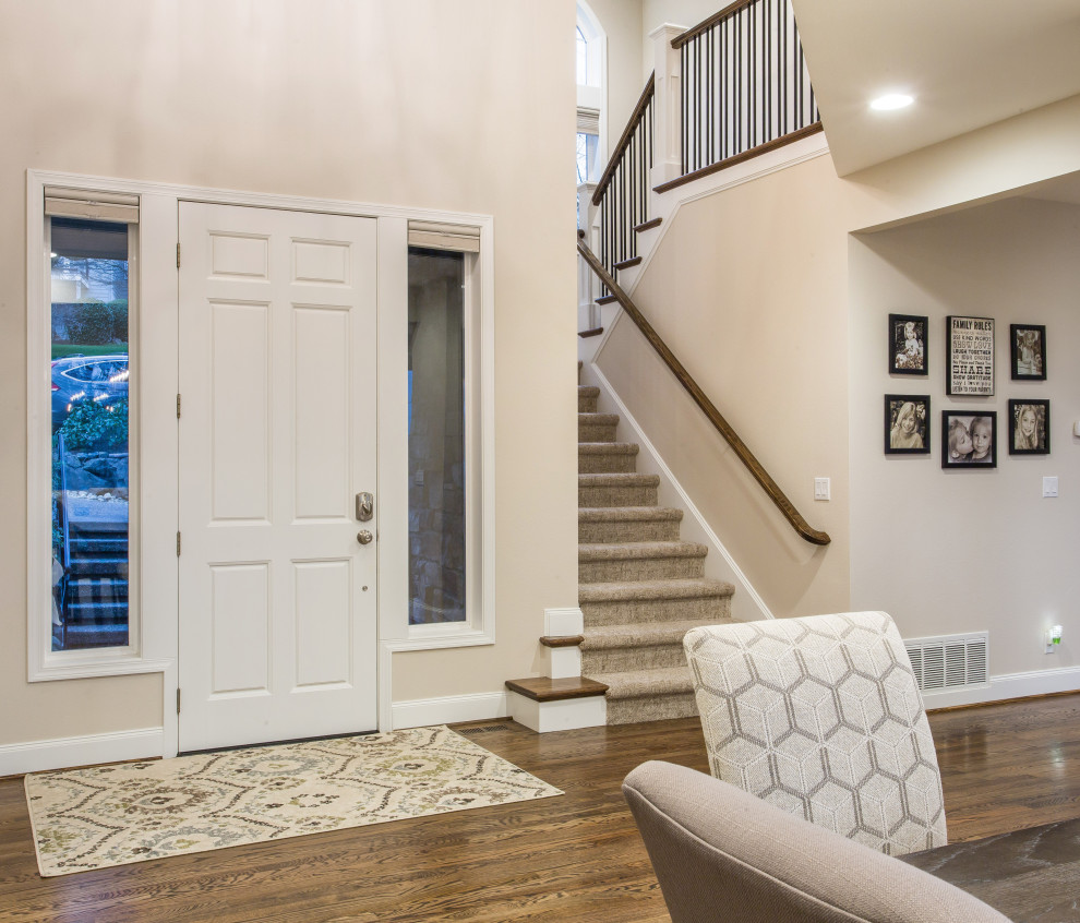 Photo of a large classic foyer in Seattle with beige walls, medium hardwood flooring, a single front door, a white front door and brown floors.