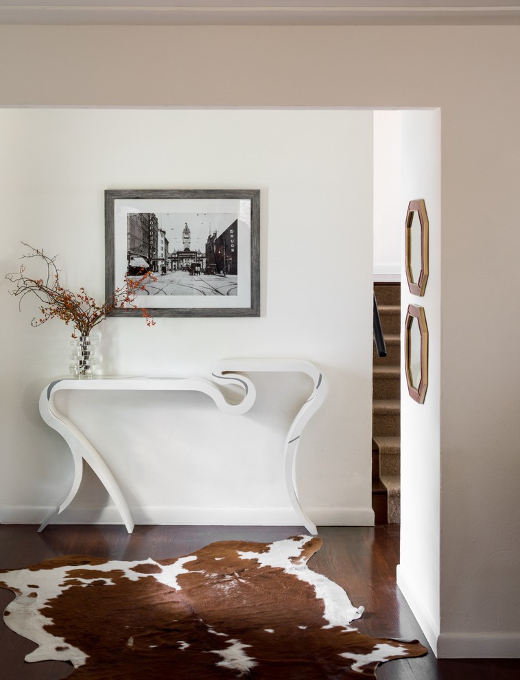 Inspiration for a small transitional dark wood floor and brown floor entry hall remodel in Denver with white walls