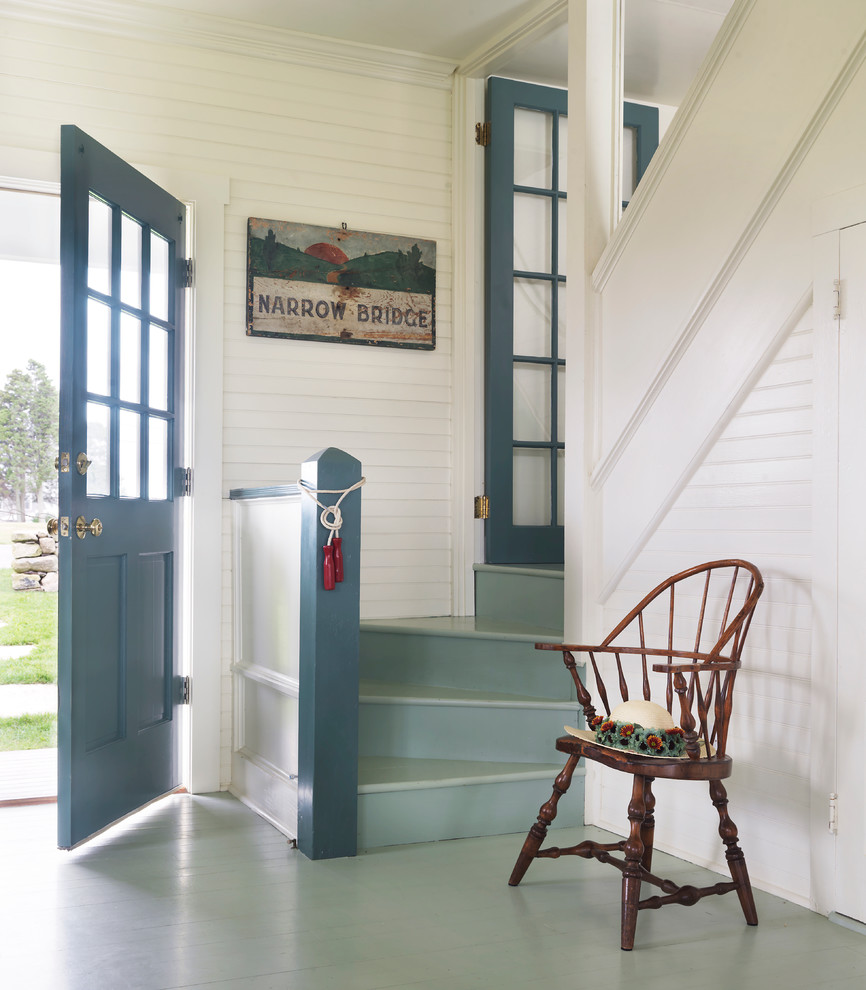Beach style painted wood floor and blue floor single front door photo in Providence with white walls and a blue front door