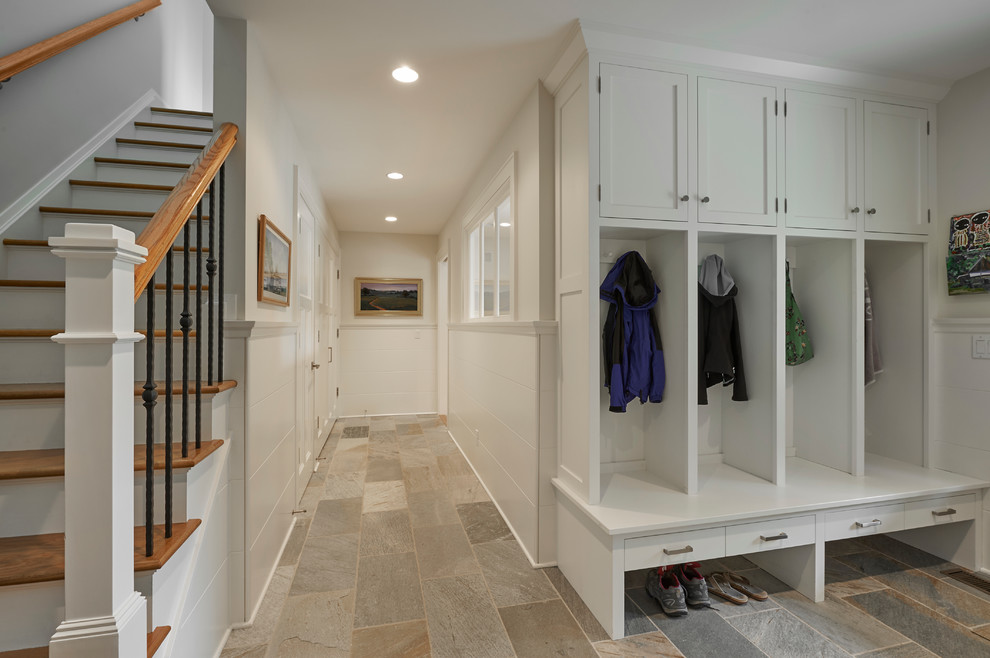 Medium sized traditional boot room in New York with white walls and granite flooring.