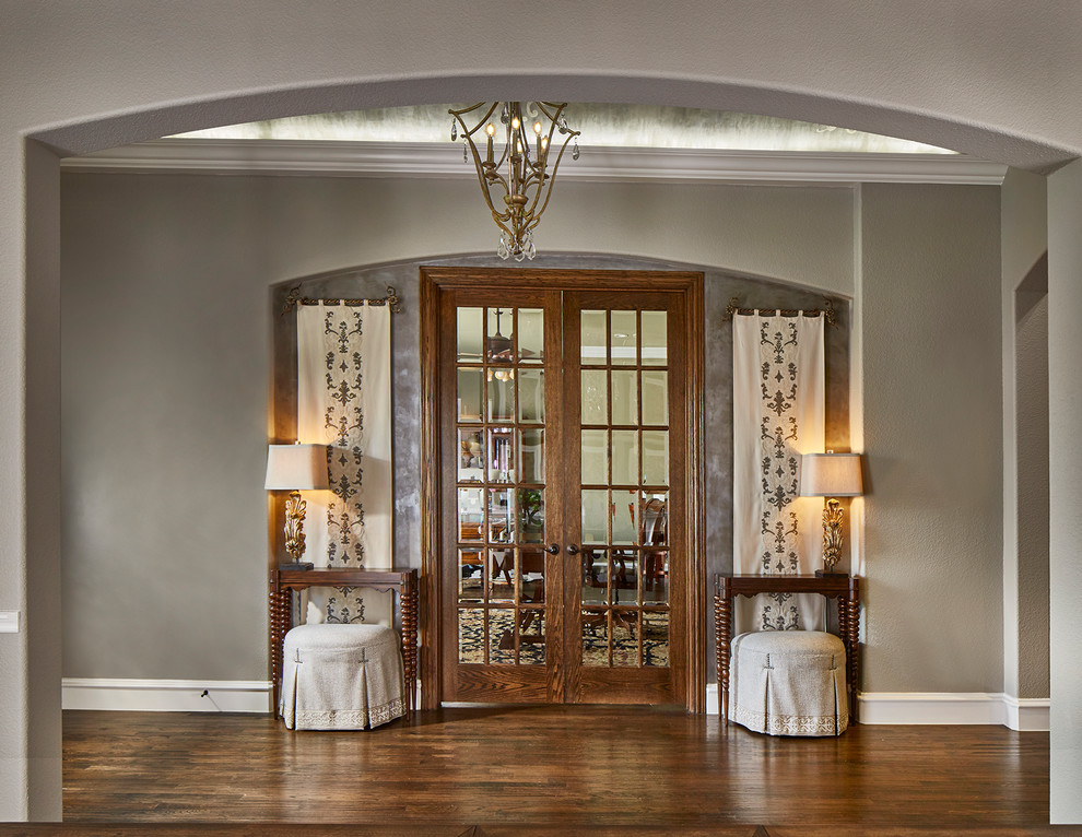 Large traditional entrance in Dallas with grey walls, medium hardwood flooring, a stable front door, a dark wood front door and brown floors.