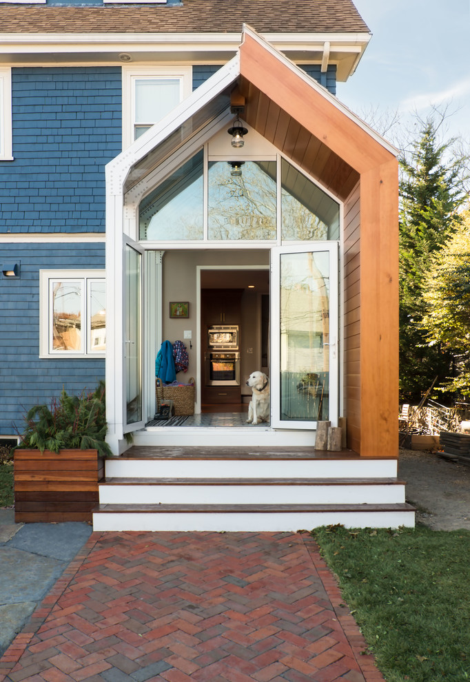 Example of a small trendy entryway design in Boston with white walls and a glass front door