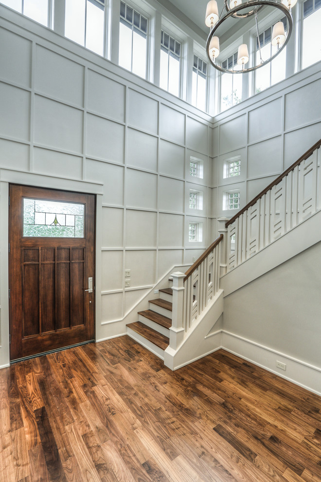 Inspiration for a large traditional foyer in Houston with grey walls, medium hardwood flooring, a single front door and a dark wood front door.