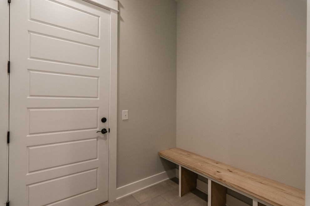 Design ideas for a small country boot room in Nashville with grey walls, porcelain flooring, a single front door, a white front door and beige floors.
