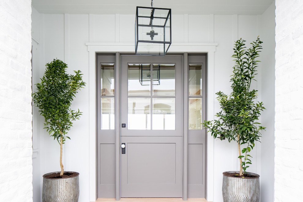 Стильный дизайн: входная дверь среднего размера в стиле кантри с белыми стенами, голландской входной дверью и серой входной дверью - последний тренд