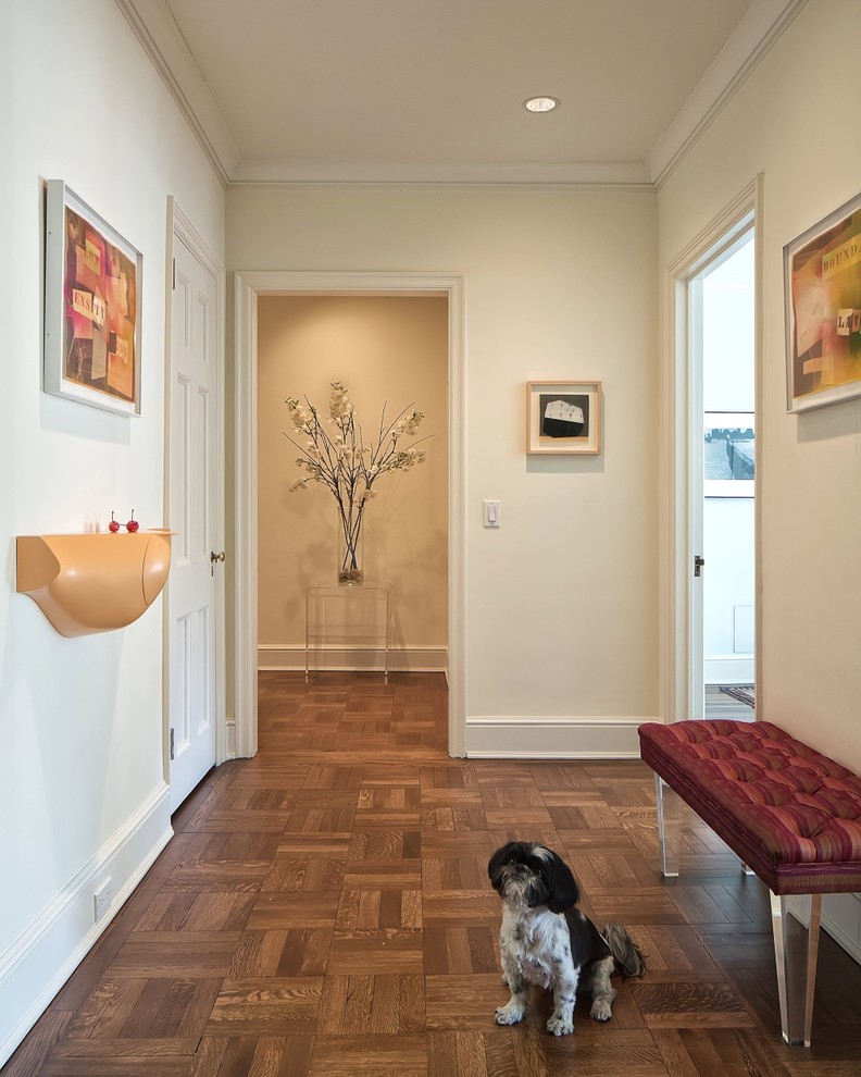Photo of a traditional hallway in New York with beige walls, medium hardwood flooring and a single front door.