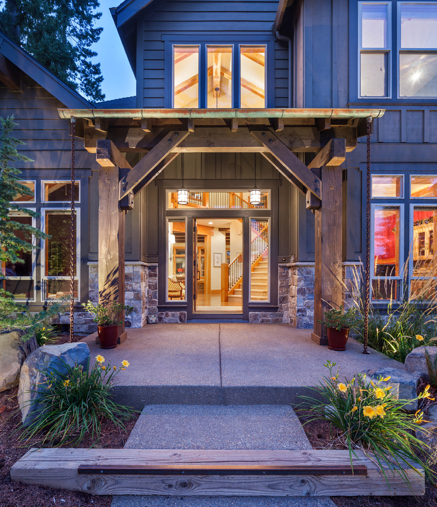 Inspiration pour une porte d'entrée chalet avec un mur marron, sol en béton ciré, une porte simple et une porte en verre.