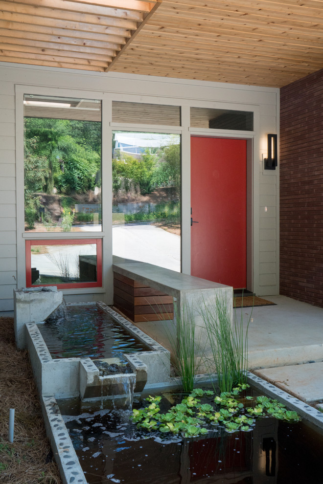 Esempio di una piccola porta d'ingresso design con una porta singola e una porta rossa
