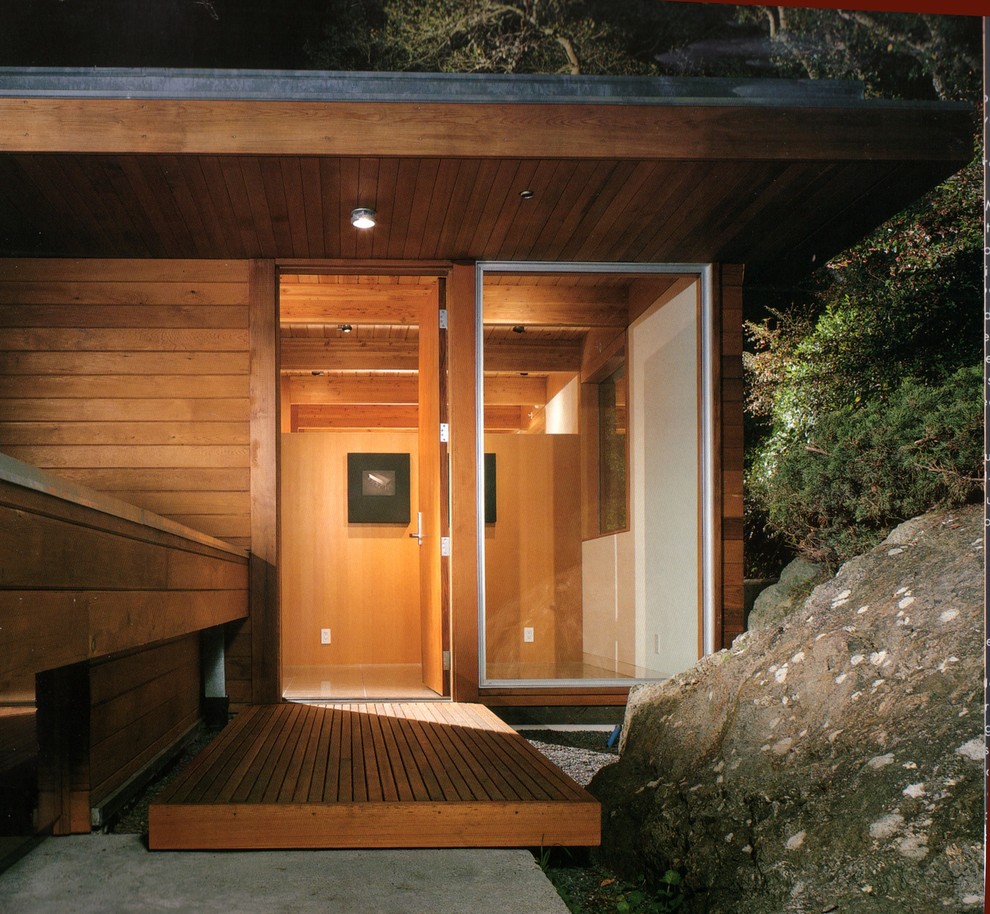 This is an example of a contemporary entrance in San Francisco with a single front door and a medium wood front door.