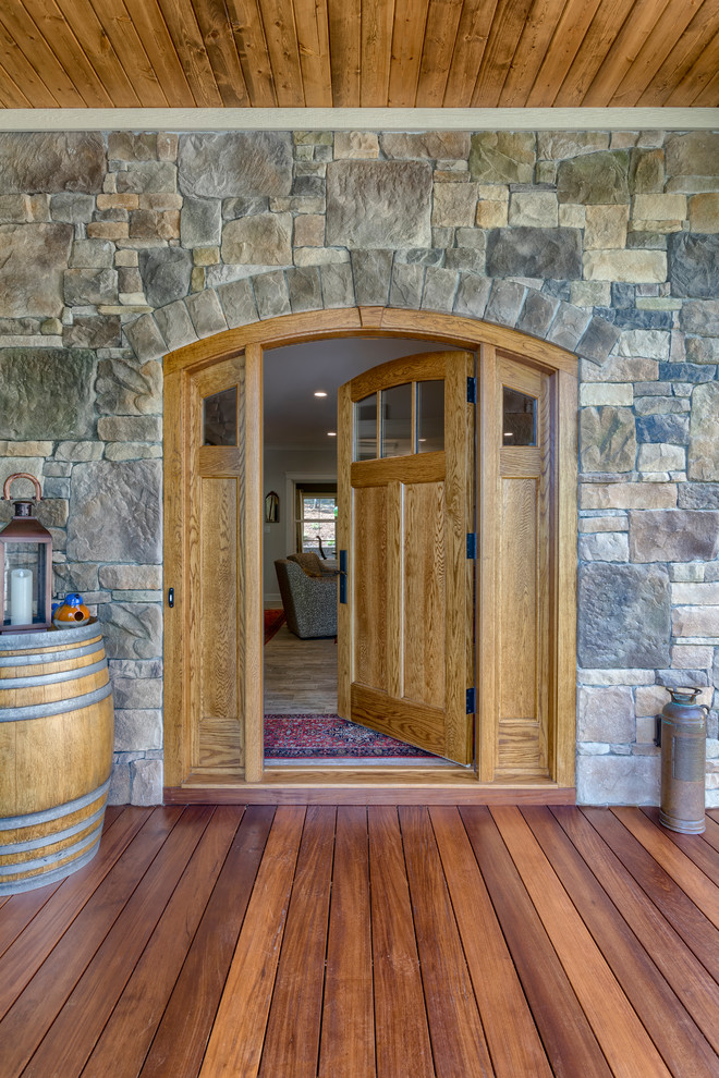Ejemplo de puerta principal de estilo americano de tamaño medio con paredes marrones, suelo de madera en tonos medios, puerta simple, puerta de madera en tonos medios y suelo marrón
