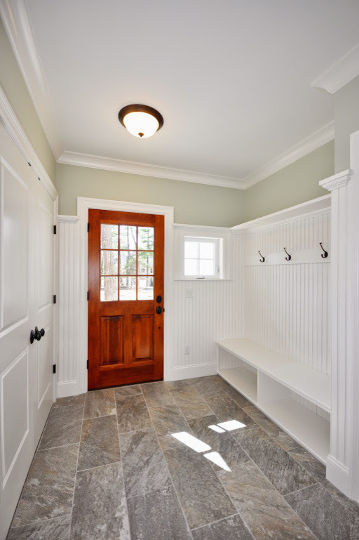 Photo of a medium sized classic boot room in Boston with grey walls, limestone flooring, a single front door and a medium wood front door.