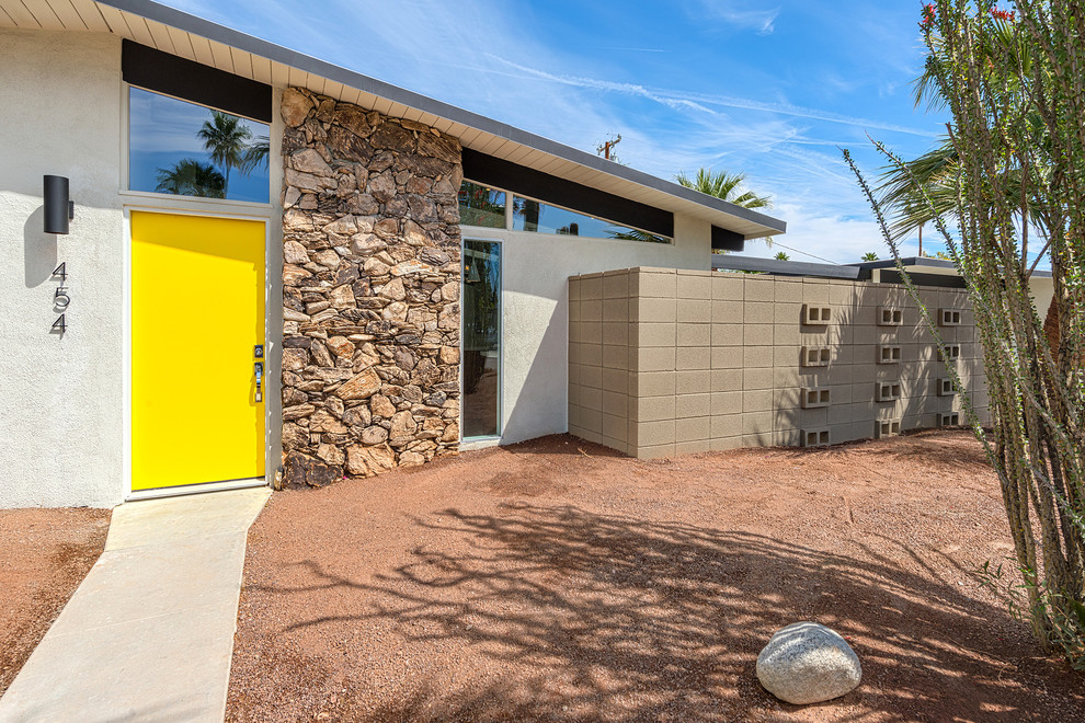 Immagine di una porta d'ingresso minimalista di medie dimensioni con una porta singola e una porta gialla