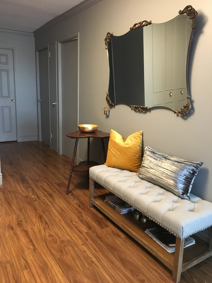 他の地域にある小さなトラディショナルスタイルのおしゃれな玄関ロビー (グレーの壁、ラミネートの床、グレーのドア、茶色い床) の写真