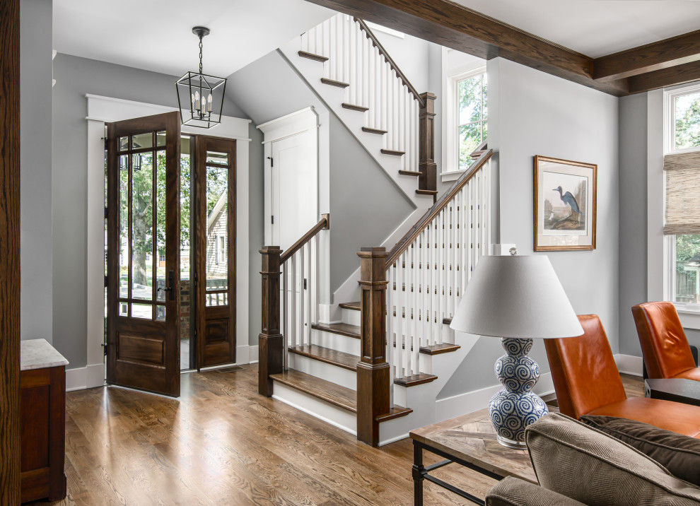 Inspiration for a mid-sized craftsman dark wood floor and exposed beam entryway remodel in Nashville with gray walls and a dark wood front door