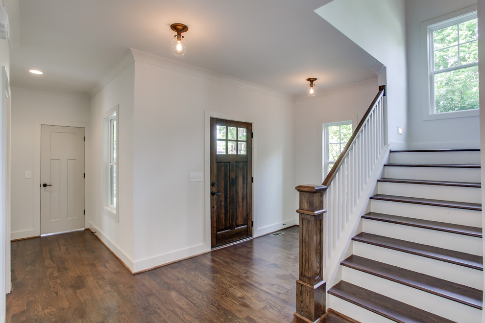 Mid-sized cottage dark wood floor entryway photo in Nashville with white walls and a dark wood front door