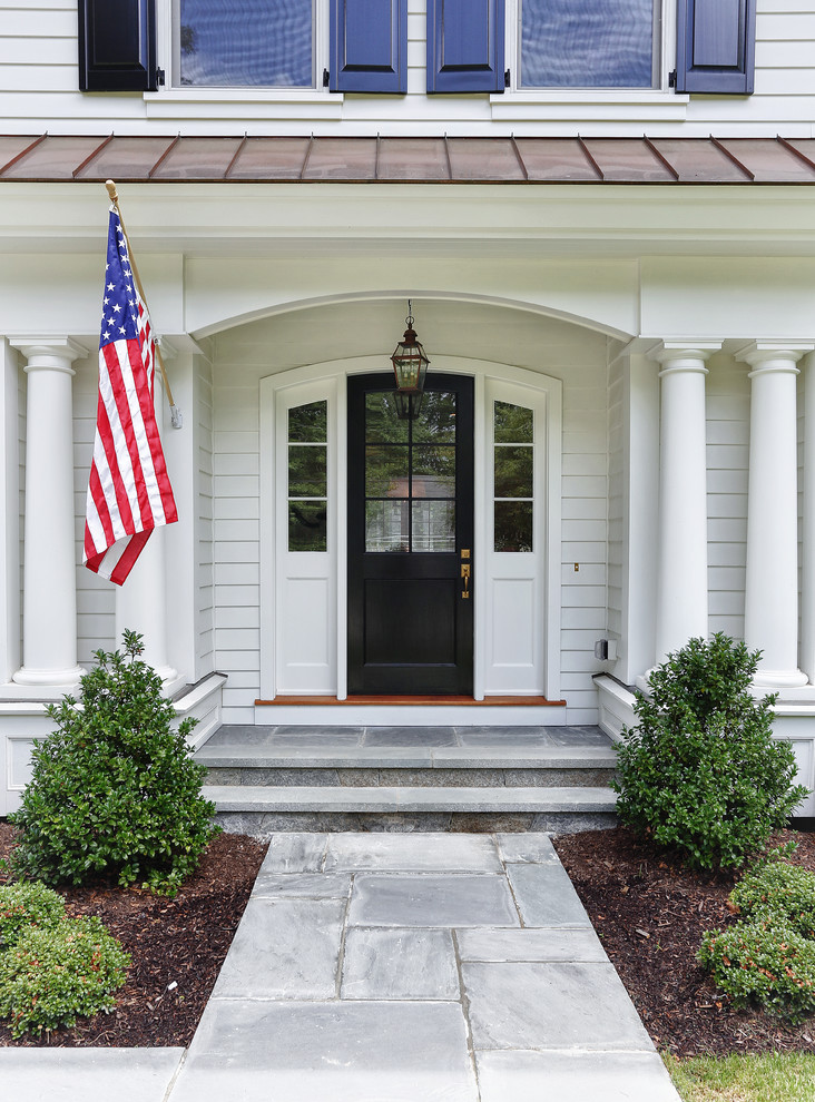 Traditional entrance in New York with a black front door.