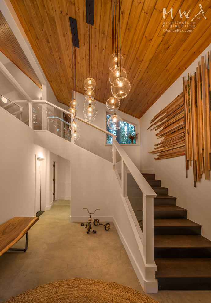 Example of a mid-sized trendy concrete floor and beige floor foyer design in Sacramento with white walls