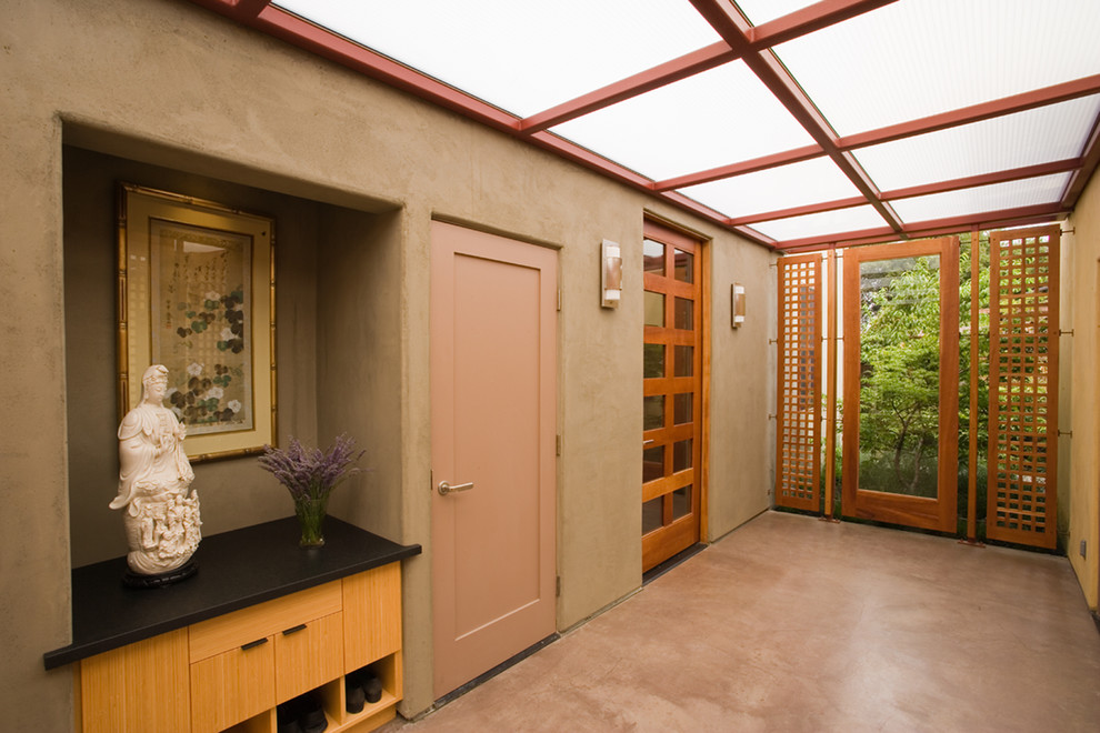 This is an example of a contemporary foyer in Los Angeles with a single front door and a glass front door.