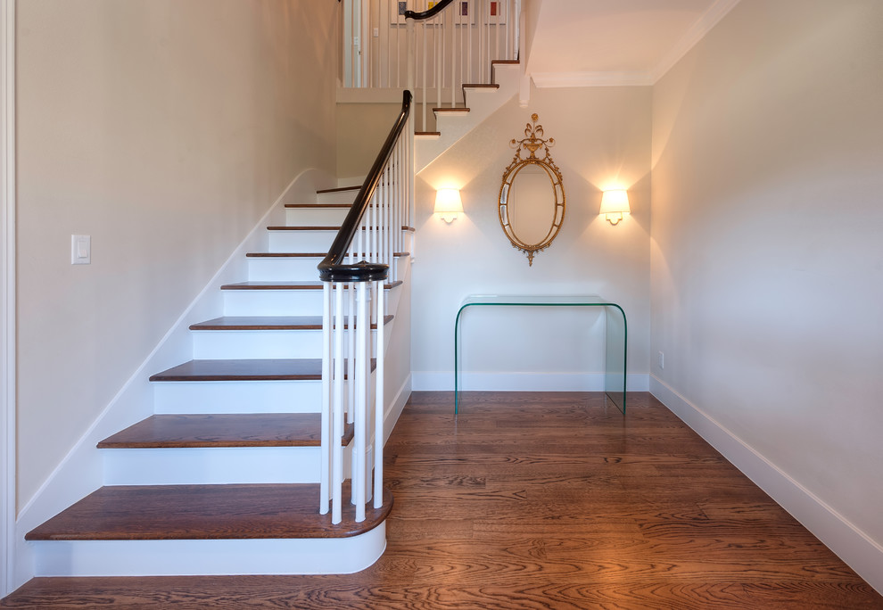 This is an example of a classic foyer in Austin with beige walls and dark hardwood flooring.