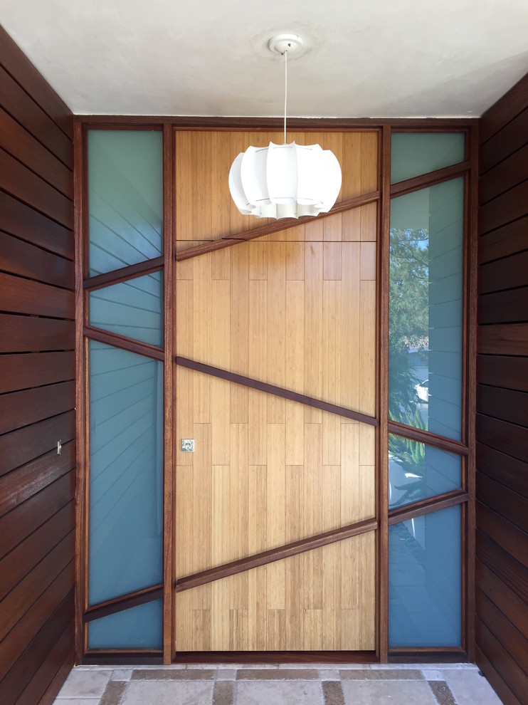 Medium sized modern entrance in Los Angeles with a single front door and a light wood front door.